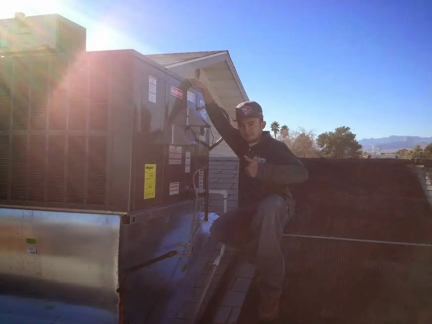 HVAC technician performing AC Tune-Up on a rooftop unit in Palmerton